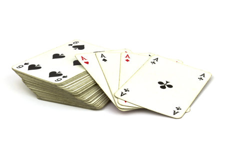 Deck of old playing cards with ace cards on top isolated on white background.