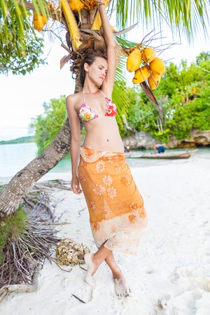 Smiling Woman Spending Chill Time Outdoor Bali Tropical Island. Exotics Summer Season Caribbean Ocean. Exotic Fruits Palm Fish Boat. Vertical Picture. Blurred backgroundの写真素材