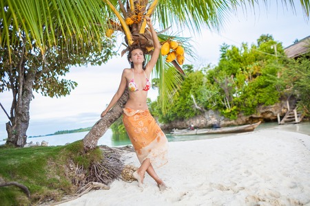 Smiling Woman Spending Chill Time Outdoor Bali Tropical Island. Exotics Summer Season Caribbean Ocean. Exotic Fruits Palm. Horizontal Picture. Long Tail Natural Wood Boat Blurred backgroundの写真素材