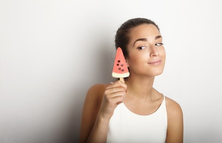 Young Pretty Women Long Hair Holding Fresh Frozen Juce Icecream Empty White Background.Beauty,Lifestyle,Fashion People Photo.Sexy Girl Smiling Camera Studio Shot.Horizontal Wide Image Portraitの写真素材