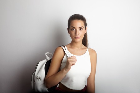Portrait Handsome Pretty Young Lady Long Hair Backpack Empty White Background.Beauty,Lifestyle,Fashion Hipster People Travel Photo.Sexy Woman Looking Camera Studio Shot.Horizontal Imageの写真素材