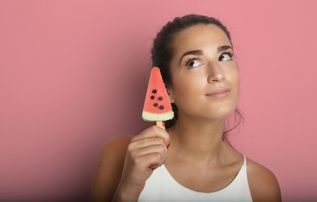 Young Pretty Women Long Hair Holding Fresh Frozen Juce Icecream Empty Bronze Background.Beauty,Lifestyle,Fashion People Photo.Sexy Girl Smiling Dreaming Camera Studio Shot.Horizontal Image Portraitの写真素材