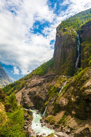 Landscape Mountains Hiking Himalayas.Beautiful View Waterfalls End Summer Season Background.Green Threes Cloudy Blue Sky Mountainous River.Nobody Image.Vertical Photoの写真素材