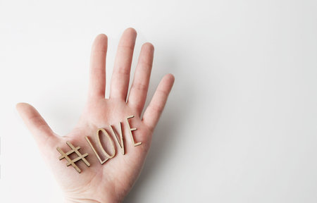 Mockup of love message with wooden letters on male hand on empty white background. Business mock-up...