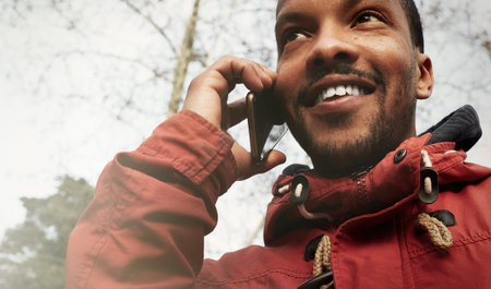 Closeup view Young happy smiling urban hipster man wearing informal clothes and using smart phone....
