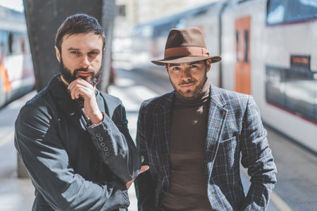 Two confident multi-ethnic bearded businessmans together wearing casual clothes and waiting the...