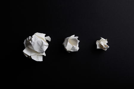Close-up of crumpled paper ball on black backgroundの写真素材