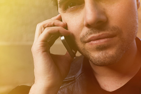 Portrait of Bearded man making call on his mobile phone.の写真素材