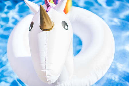 Closeup view of Inflatable colorful white unicorn at the swimming pool. Fun time in the Summer at swimming pool. conceptの写真素材