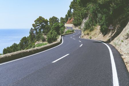 Serpentine road and amazing view of sea and mountain landscape.の写真素材