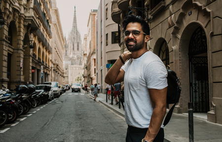 Traveler male discover a big europe city, travel and active lifestyle concept.Bearded Tourist Man with black leather bag enjoy beautiful city travelの写真素材