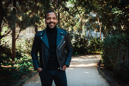 Confident stylish african american man wearing black leather jacket outdoor. Street wear fashion black man.の写真素材