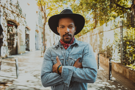 Confident African American male hipster wearing black hat and jeans shirt. Street wear fashion black man . Lifestile conceptの写真素材