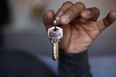 African black man holding home keys in hand. Closeupの写真素材