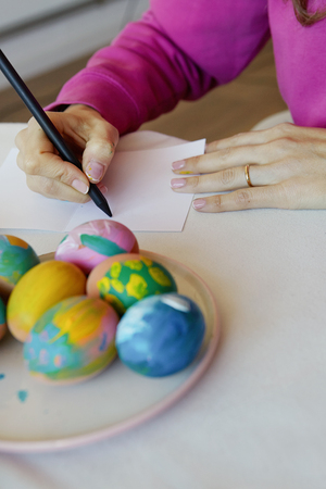 Happy easter. Young woman painting easter eggs. Happy family preparing for Easter.の写真素材