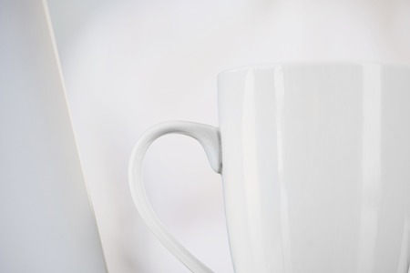 White cup isolated on white blurred background.の写真素材