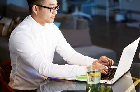 Young asian businessman working with laptop at office.の写真素材