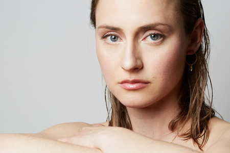Beauty portrait of a teen female with natural makeup over white background. Cosmetology and Advertisement.の写真素材