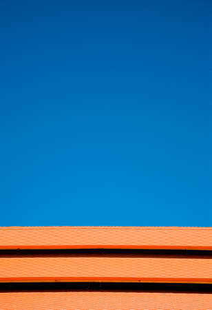 Blue sky orange tilesの写真素材