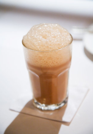 cup of tea with milk with bubblesの写真素材