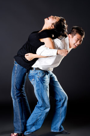 asian young couple having fun with the guy try to carry up the girl