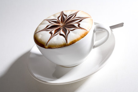 beautifully decorated cup of hot coffee with a star shape chocolate flowerの写真素材