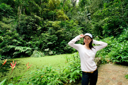 asian young woman enjoying green nature environment in the parkの写真素材