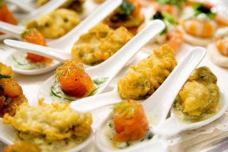 finger foods on the spoons ready to be served