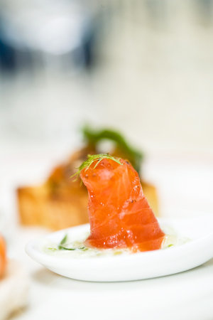 a raw salmon finger food appertizer is servedの写真素材