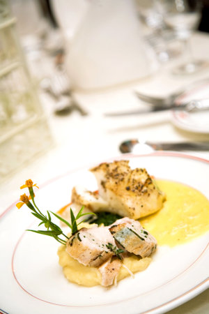 a main course meal served with chicken and fish cutlet