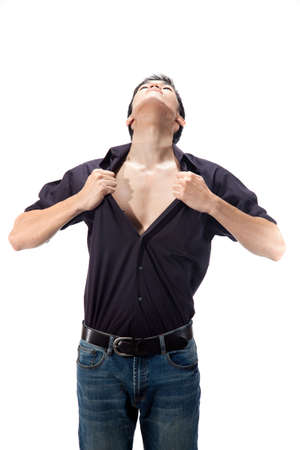 young man pulling open his shirt with head upの写真素材