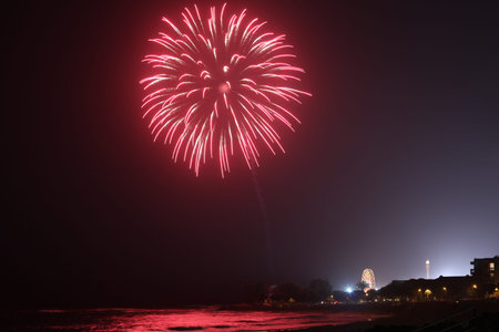 Long exposure shot on Canon DSLR of fireworks show over the ocean at the carnival. Low noise, high...