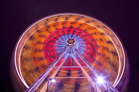 Long exposure looking up view of the ferris wheel at the carnival at night  のeditorial素材