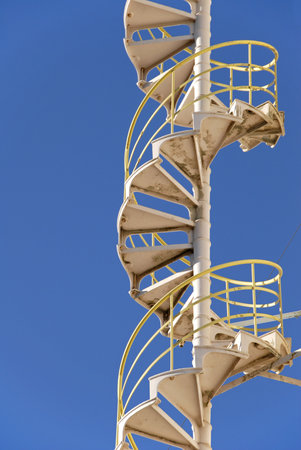 Industrial Steel Spiral Stairs with Safety Railingの写真素材