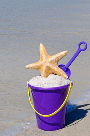 Beach Bucket full of sand with a Starfishの写真素材