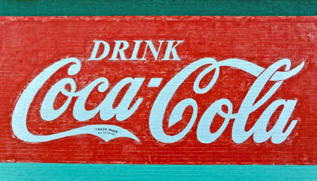 VILLA RICA,GA UNITED STATES - CIRCA SEPTEMBER 2013: A weathered brick wall displays the Coca-Cola logo circa September 2013. のeditorial素材