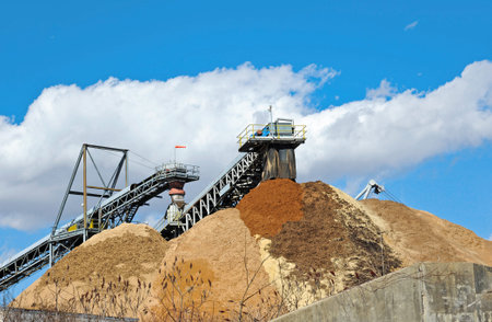 Conveyor Dumping Wood Chips and Biomass in a Pile at a Paper Millの写真素材