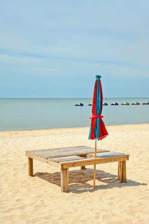 Colorful Beach Umbrella and Sun Bathing Deck on the Beachの写真素材