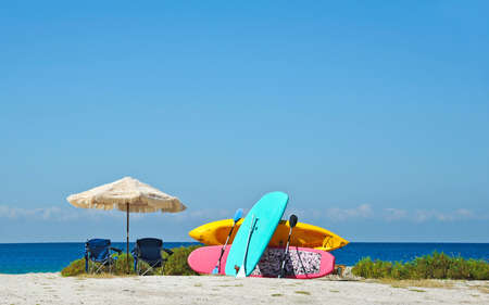 Umbrellas, Chairs, Paddle Boards and Kayak Rentals on the Beach  の写真素材