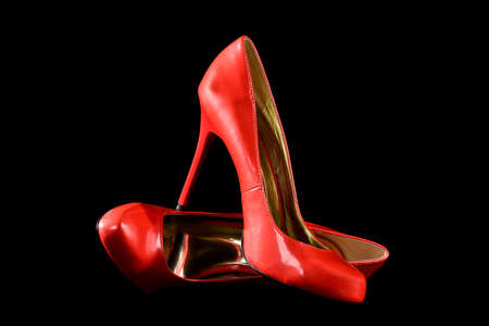 Red Leather High Heel Shoes isolated on Black Backgroundの写真素材