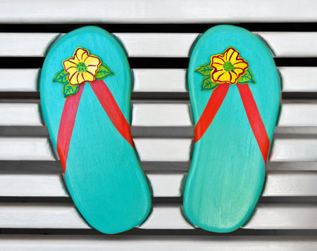 Colorful Wooden Flip-Flips on the back of a White Wood Bench