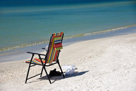 An Empty Bright Colored Beach Chair on the Beach