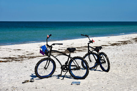 Two Bicycles with Baskets parked on the SAndy Beach of Anna Maria Island, Floridaの写真素材