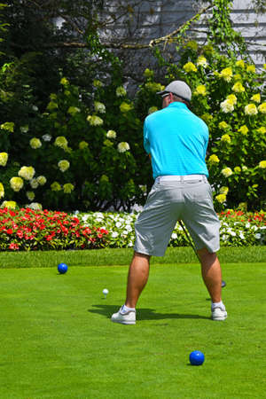 Young Man Looking Down the Fairway Getting Ready to Tee Off WIth a Driver. の写真素材
