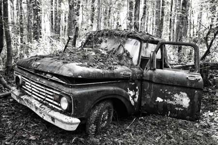 White, GA / USA - October27, 2018 - Old Scrap Ford Truck in the Woods at a Junk Yard.のeditorial素材