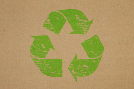 Recycled rubber stamp symbol on brown paper backgroundの写真素材