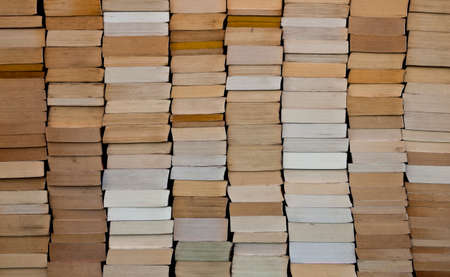 Pile of paperback book ends stacked backgroundの写真素材