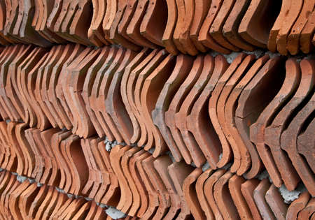 Wall made from red clay roof tilesの写真素材