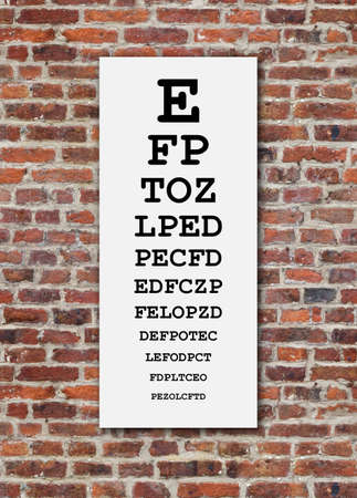Eye test chart on brick wall backgroundの写真素材