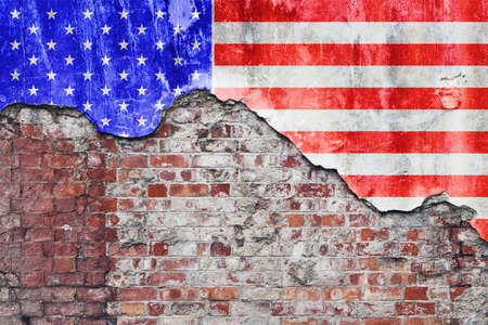 Grungy old brick wall with American flag on broken render surfaceの写真素材